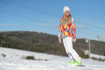 snowboarder on slopes in the sunny morning