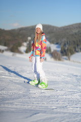 snowboarder on slopes in the sunny morning
