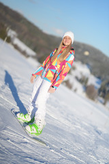 snowboarder on slopes in the sunny morning