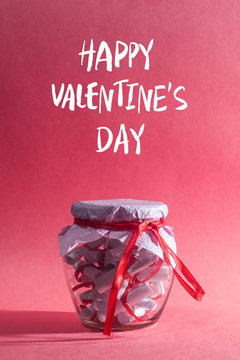 Happy valentine's day. Glass jar, full of rolled papers with sweet dreams