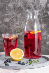 Fresh blueberry summer mojito cocktail. Blueberry lemonade or sangria on kitchen countertop.