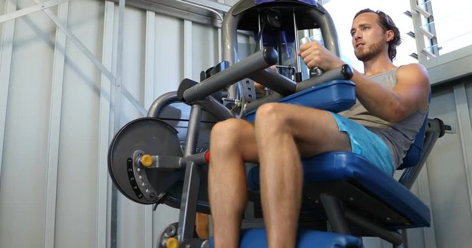 Fitness Man Doing Hamstring Curls In Leg Curl Machine Aka Hamstring Exercise Machine. 59.94 FPS Slow Motion.