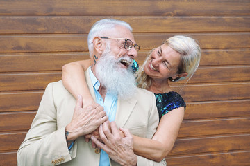 Happy fashion seniors couple embracing outdoor - Mature elegant people laughing and having a tender...