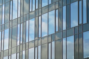 Facade fragment of a modern office building. Exterior of glass wall with abstract texture.