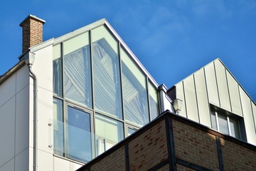 Fototapeta premium Modern apartment buildings on a sunny day with a blue sky. Facade of a modern apartment building