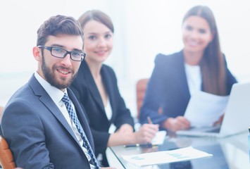 closeup.confident businessman sitting behind a Desk.