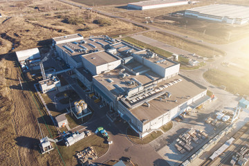 Aerial view from drone of warehouse storage or industrial factory or logistics center. Industrial buildings and equipment machines 