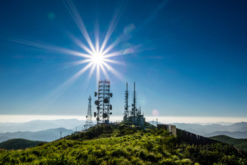 Obraz premium The sun is rising on the broadcast relay tower of Hambaeksan Mountain.