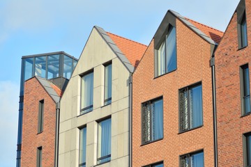 Fototapeta na wymiar Modern apartment buildings on a sunny day with a blue sky. Facade of a modern apartment building