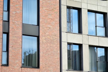 Modern apartment buildings on a sunny day with a blue sky. Facade of a modern apartment building