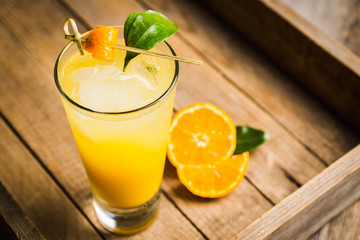 Fresh cocktail with mandarines on the rustic background. Selective focus. Shallow depth of field.