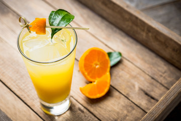 Fresh cocktail with mandarines on the rustic background. Selective focus. Shallow depth of field.