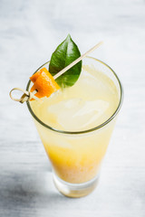 Fresh cocktail with mandarines on the rustic background. Selective focus. Shallow depth of field.