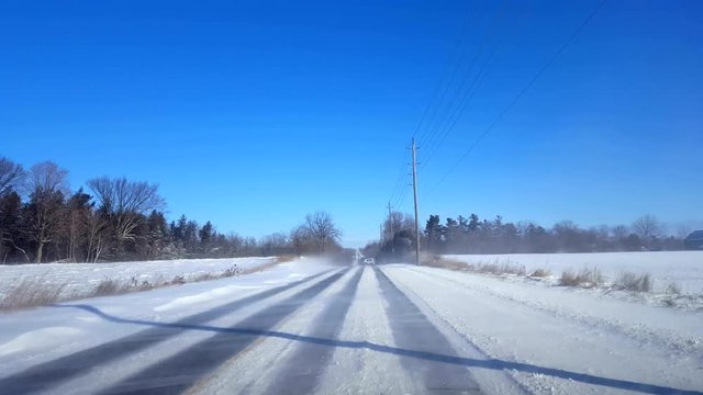 Driving Winter Rural Road in Day.  Driver Point of View POV Countryside Street With Snow in Daytime.
