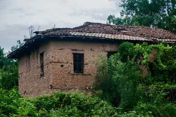 Fototapeta na wymiar Old abandoned weathered retro vintage rural brick wall house