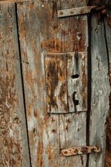 Old grunge weathered aged wooden rural door detail closeup