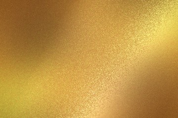 Reflection on rough gold metallic sheet surfaces, abstract texture background