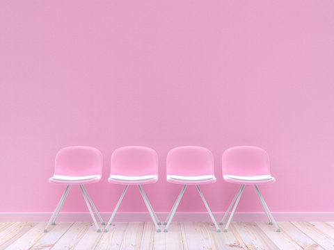 Four pink chairs on concrete wall