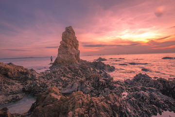 The background of the sea by the evening sea, with natural beauty (sea water, rocks, sky) and fishermen are fishing by the river bank, is a pleasure during travel.