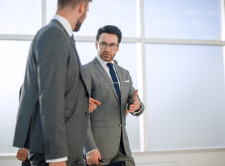 Fototapeta premium Two businesspeople walking in corridor talking