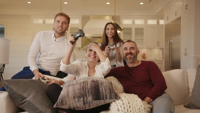 Friends playing video games in modern home / having fun 