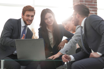 Beautiful business people are using a laptop during the conferen