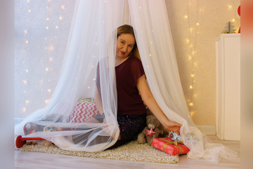 Beautiful girl behind the white curtain