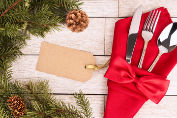Close up on table settings with a red napkin and a cutlery, directly above. Empty tag name for your...