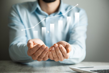 businessman holding a graph