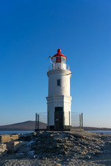Fototapeta na wymiar Seascape overlooking The Tokarev lighthouse against the blue sky.