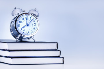  alarm clock on book with copy space. knowledge concept