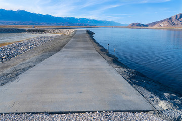 Fototapeta na wymiar Concrete service road on Owens Lake, California, USA