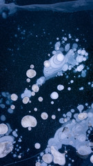 The frozen lake surface, showing a variety of textures. Blue background of Ice texture. 