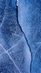 The frozen lake surface, showing a variety of textures. Blue background of Ice texture. 