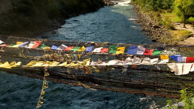 Suspension bridge covered in prayer flags near Paro, Bhutan