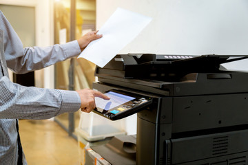 Business man Hand press button on panel of printer, printer scanner laser office copy machine...