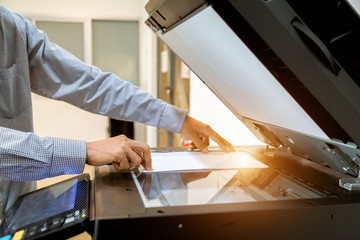 Business man Hand press button on panel of printer, printer scanner laser office copy machine...