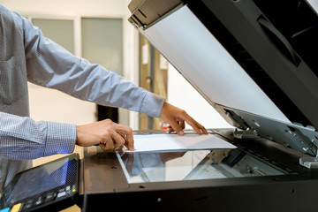 Business man Hand press button on panel of printer, printer scanner laser office copy machine...