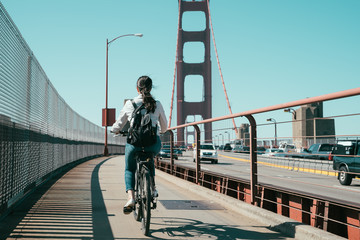 Bicyclist riding bike on Golden Gate Bridge
