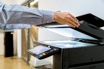 Business man Hand press button on panel of printer, printer scanner laser office copy machine...