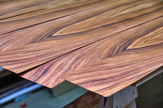 Santos Rosewood veneer . Wood texture. Woodworking and carpentry production.