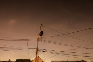 Utility Pole with multiple black electrical wires
