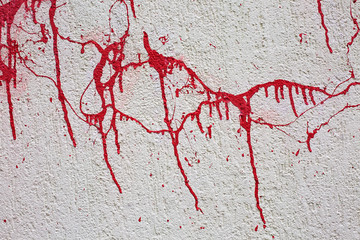 Background texture wall with red blood like paint streaks.