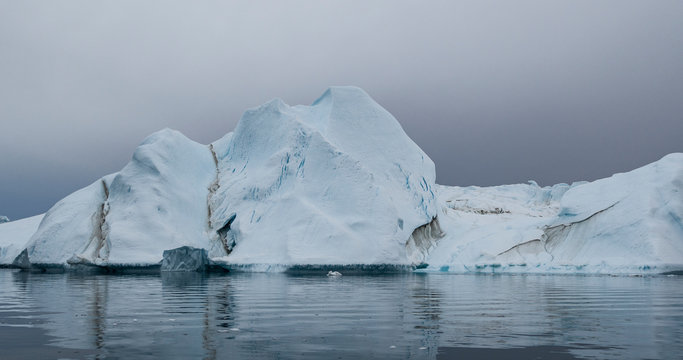 Global Warming and Climate Change - Giant Iceberg from melting glacier in Ilulissat, Greenland. Imageof arctic nature landscape famous for being heavily affected by global warming.