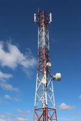 Telecommunications mast showing lattice steel and dish antennas.