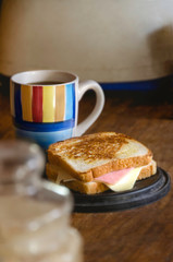 cup of coffee and sandwich on wooden table