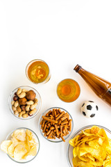 Snacks for watching football on TV. Watching sports. Chips, nuts, rusks near beer and soccer ball...