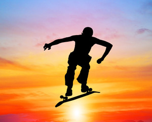 Fototapeta na wymiar silhouette of skateboarder on blurry sunrise background.