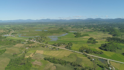 Aerial view of rice terrace, agricultural land of farmers. Tropical landscape with farmlands on Luzon, Philippines. Rice fields against the blue sky.