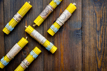 Buddhism. Candles with Yantras and mantras in sanskrit on dark wooden background top view copy...